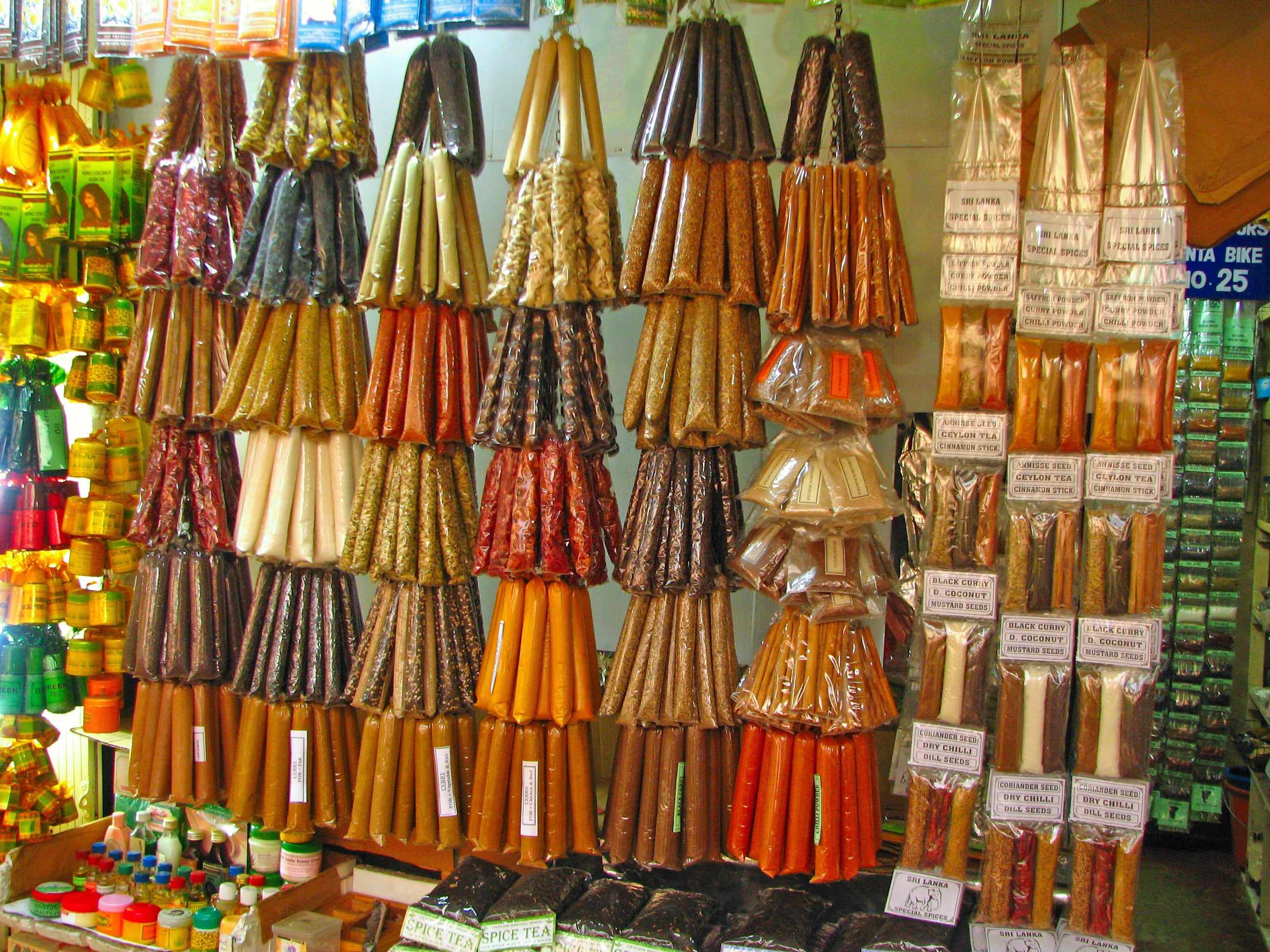 Cinnamon, herbs and spices hanging in a Kandy market stall